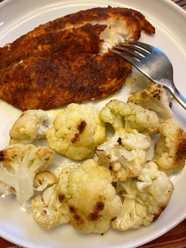 eating baked tilapia with roasted cauliflower