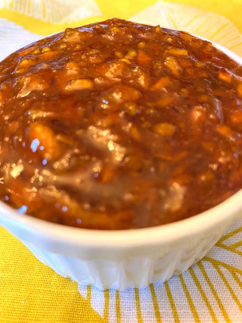 a white bowl full of orange marmalade 