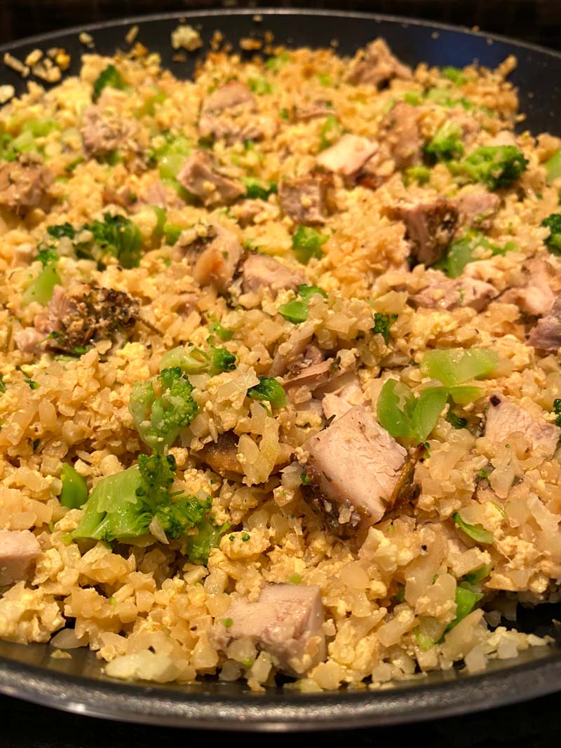 close up of chicken cauliflower fried rice in a pan