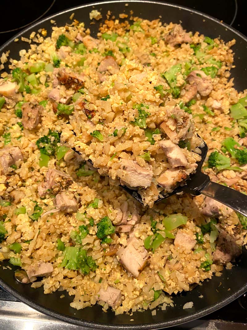 spoonful of cooked cauliflower fried rice