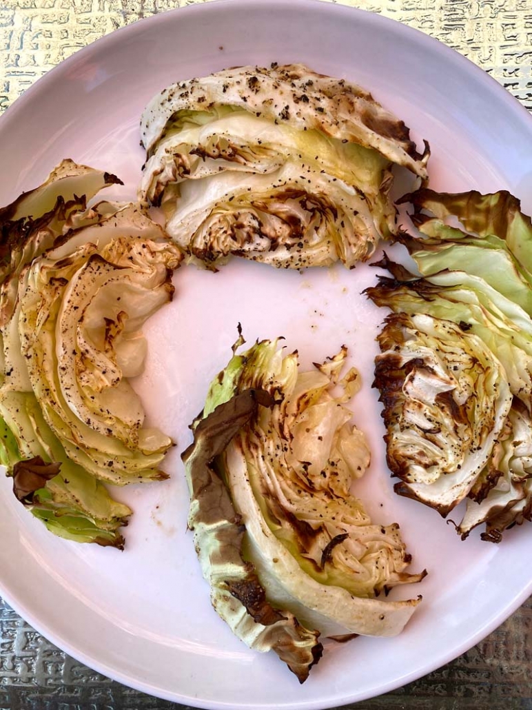 roasted cabbage wedges served on a white plate