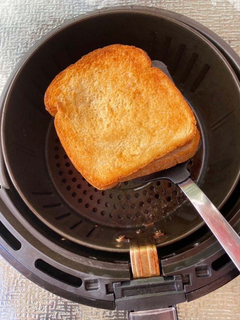 using a spatula to remove grilled cheese from air fryer basket 