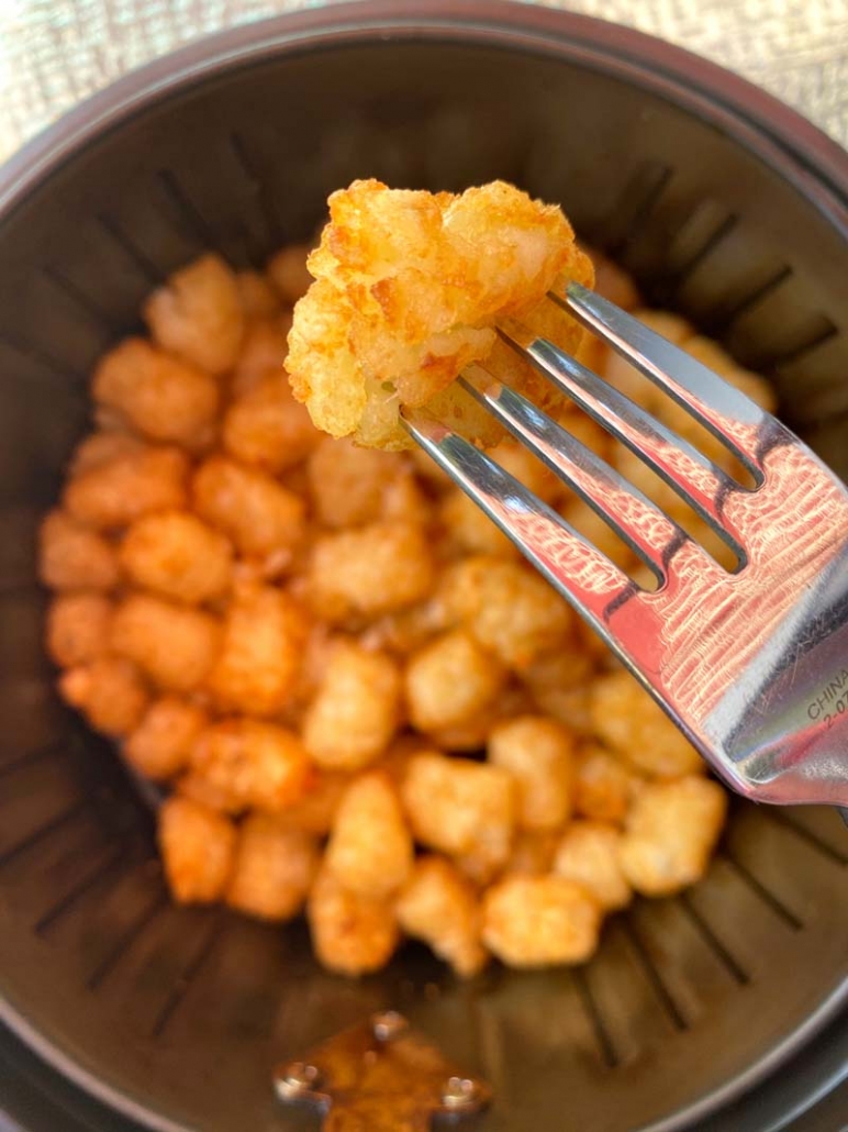 eating tater tots with a fork