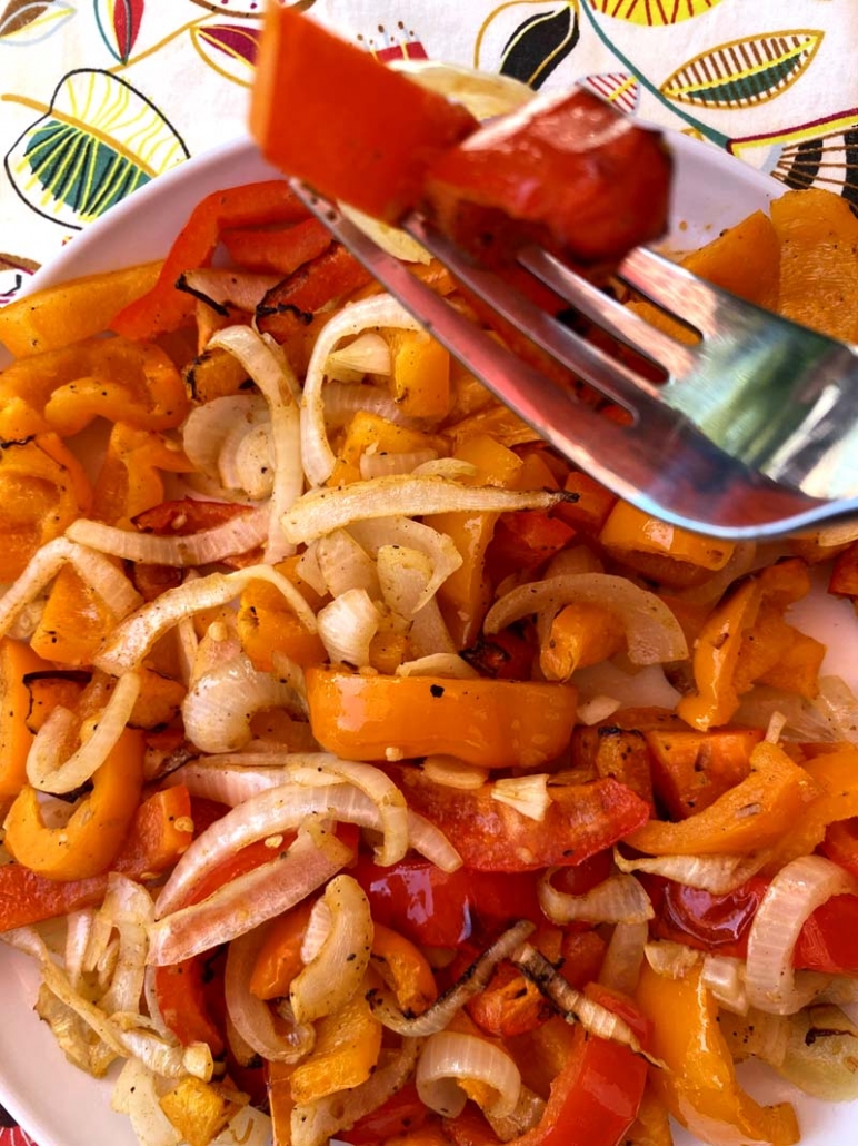 eating peppers and onions with a fork 