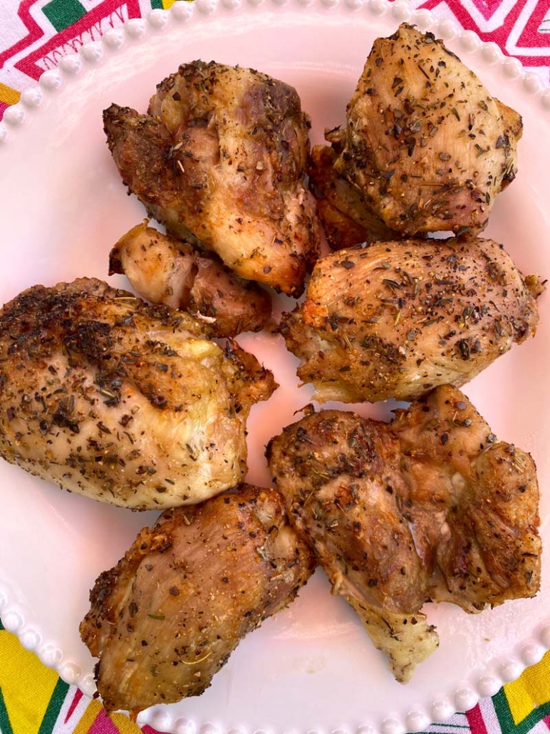 roasted chicken thighs on a white plate 