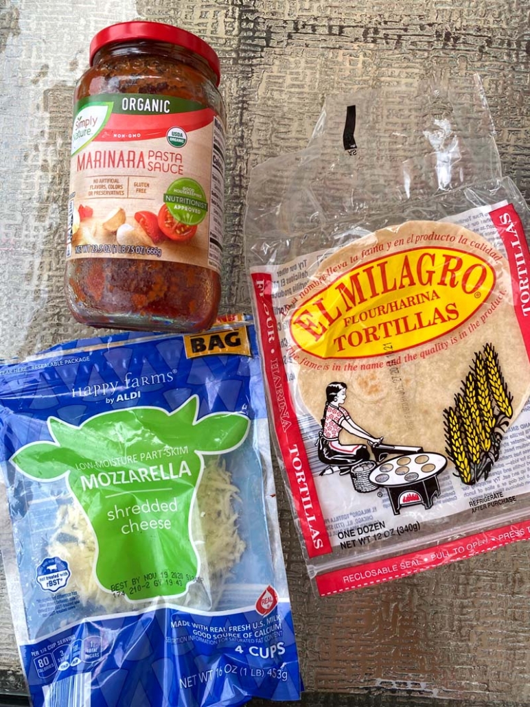 ingredients to make tortilla pizza: marinara sauce, shredded cheese and flour tortillas