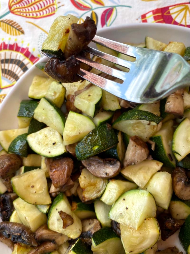 eating roasted mushrooms and zucchini