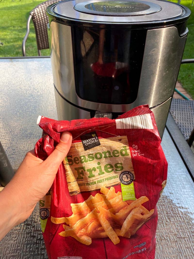 a bag of seasoned frozen french fries and an air fryer 