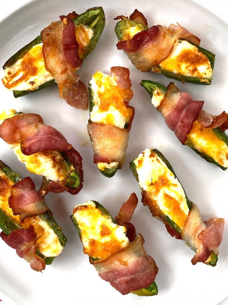 bacon-wrapped jalapeno poppers on a white plate