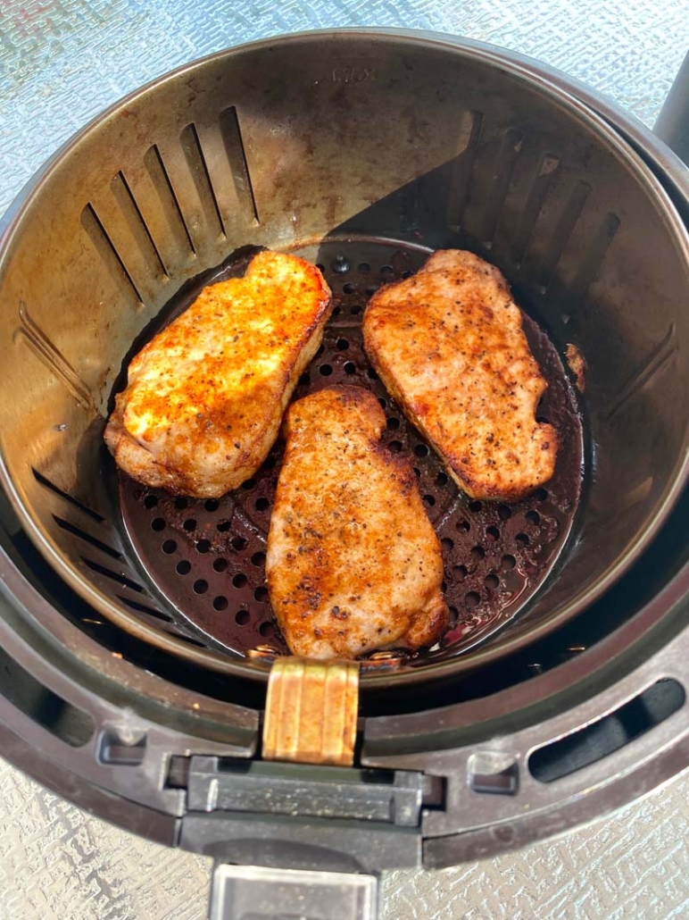 3 cooked boneless pork chops in an air fryer 