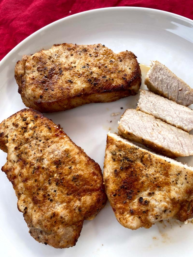 Air fryer boneless pork chops on a plate sliced 