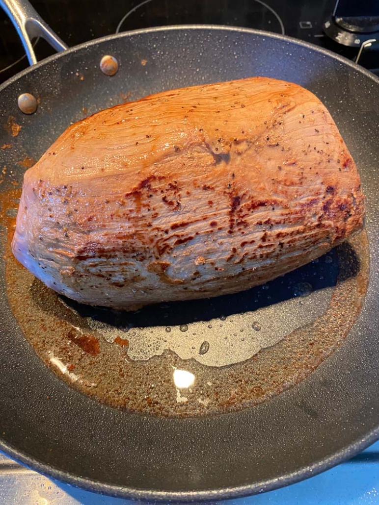 A completely browned eye of roast steak 