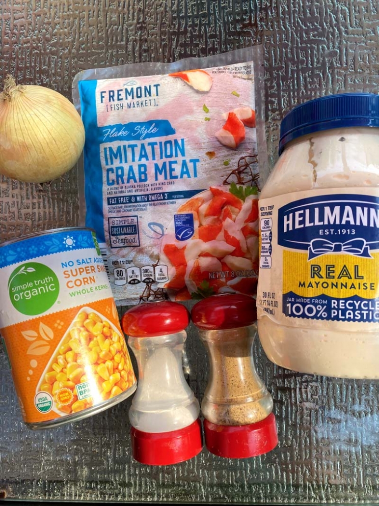 Ingredients for crab and corn salad - canned corn, imitation crab, onion, salt and pepper and mayo