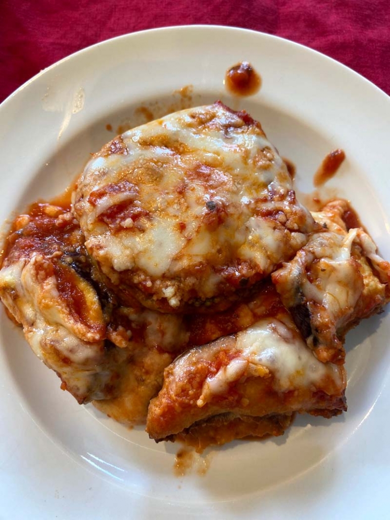 A plate of baked eggplant parmesan that is low-carb