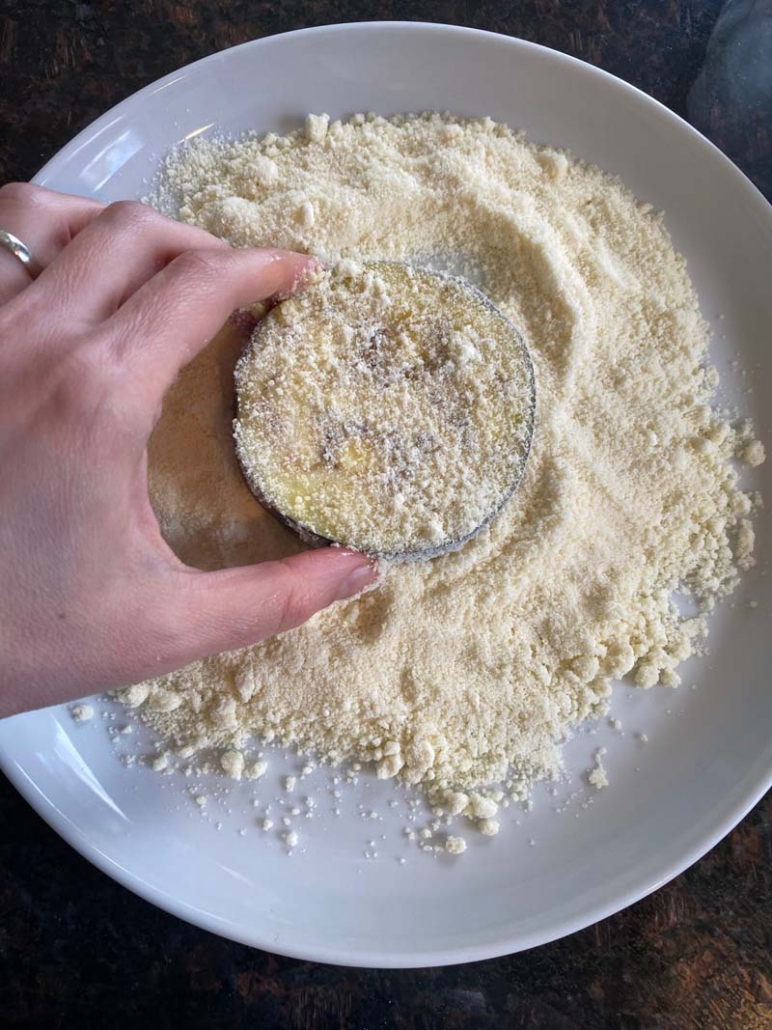 dipping eggplant into almond flour 