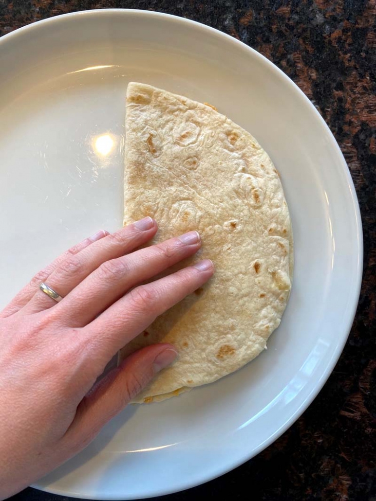 Folding the flour tortilla in half 