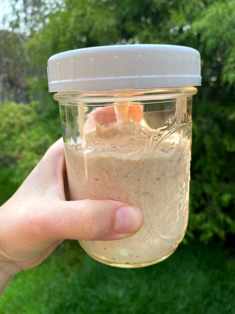 Mixing the homemade salad dressing in a mason jar