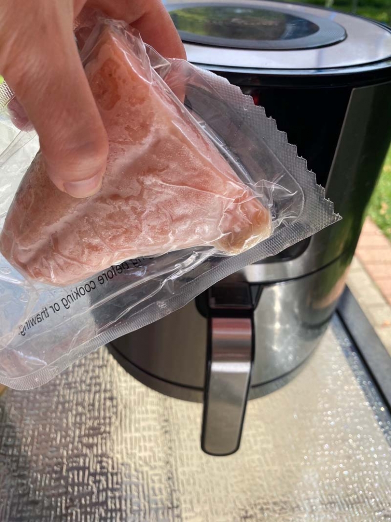 adding frozen salmon fillets to the air fryer