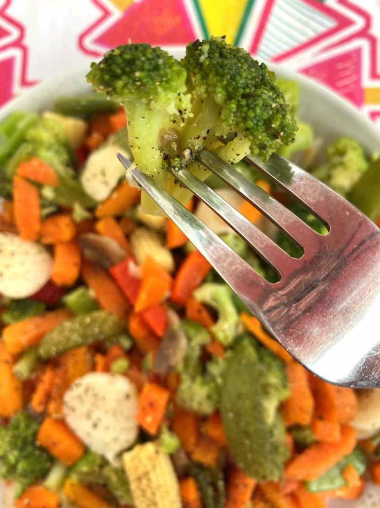 cooked broccoli floret on a fork