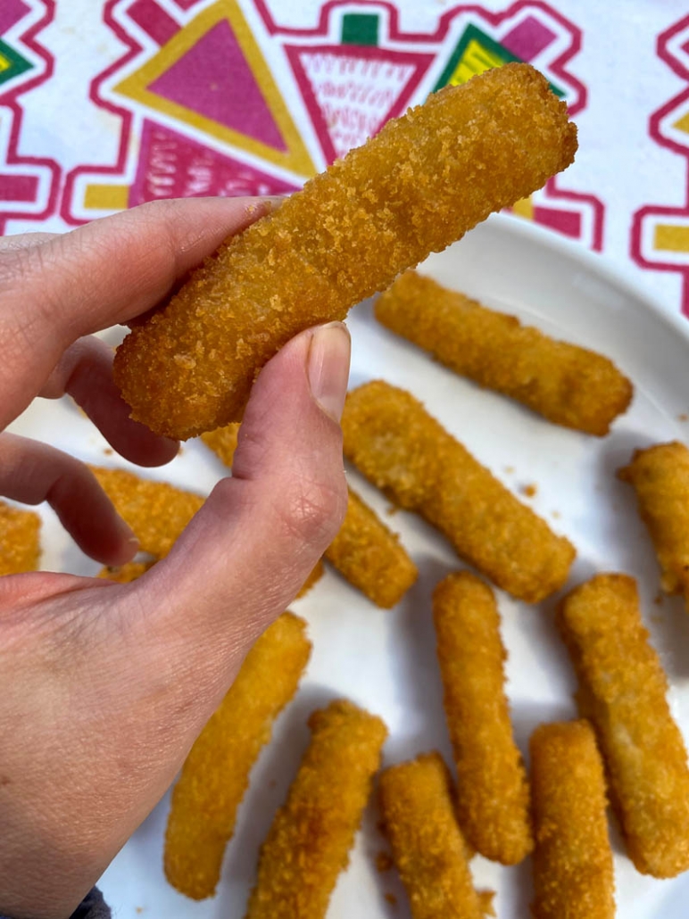 eating a fish stick with hands