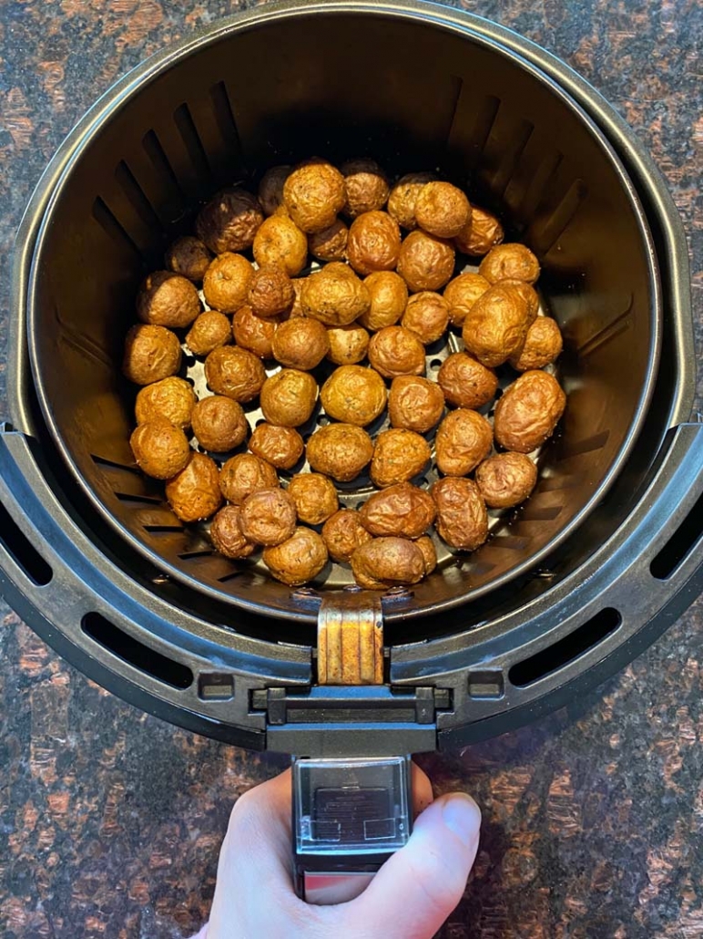 baby potatoes in an air fryer basket 