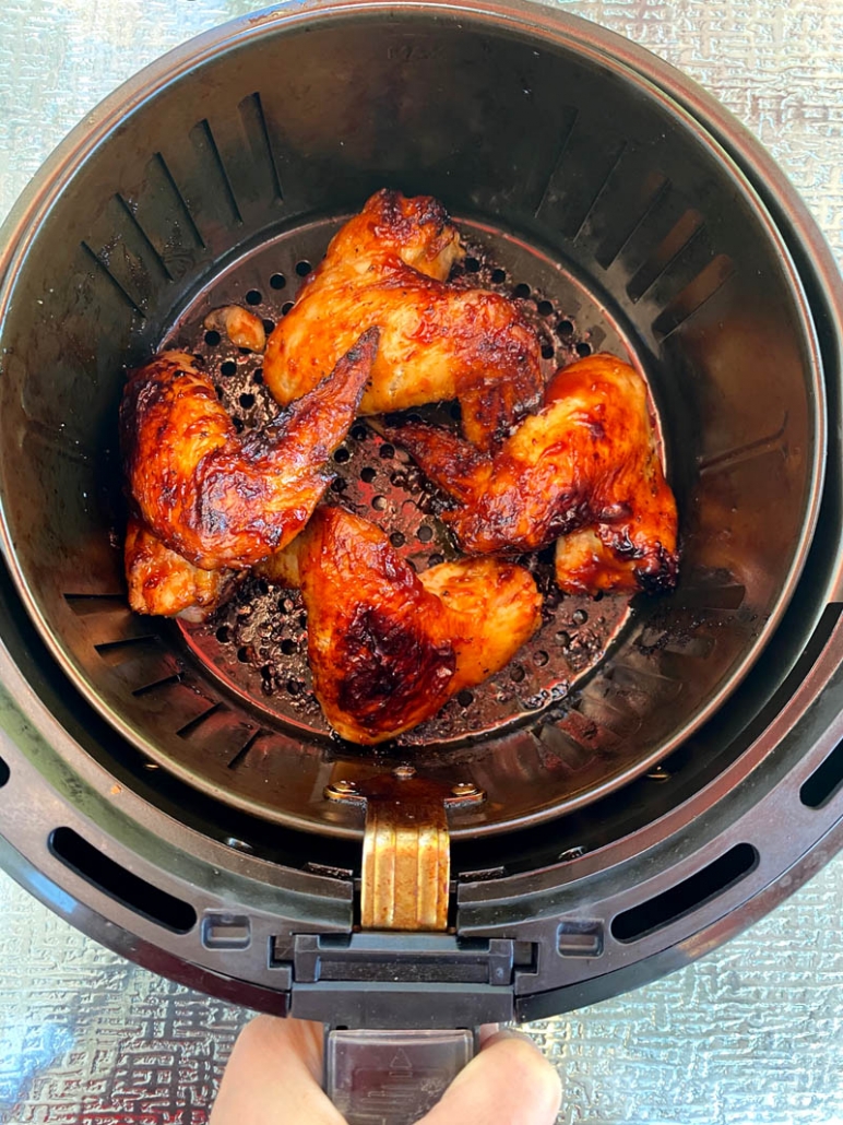 cooking chicken wings in an air fryer basket 