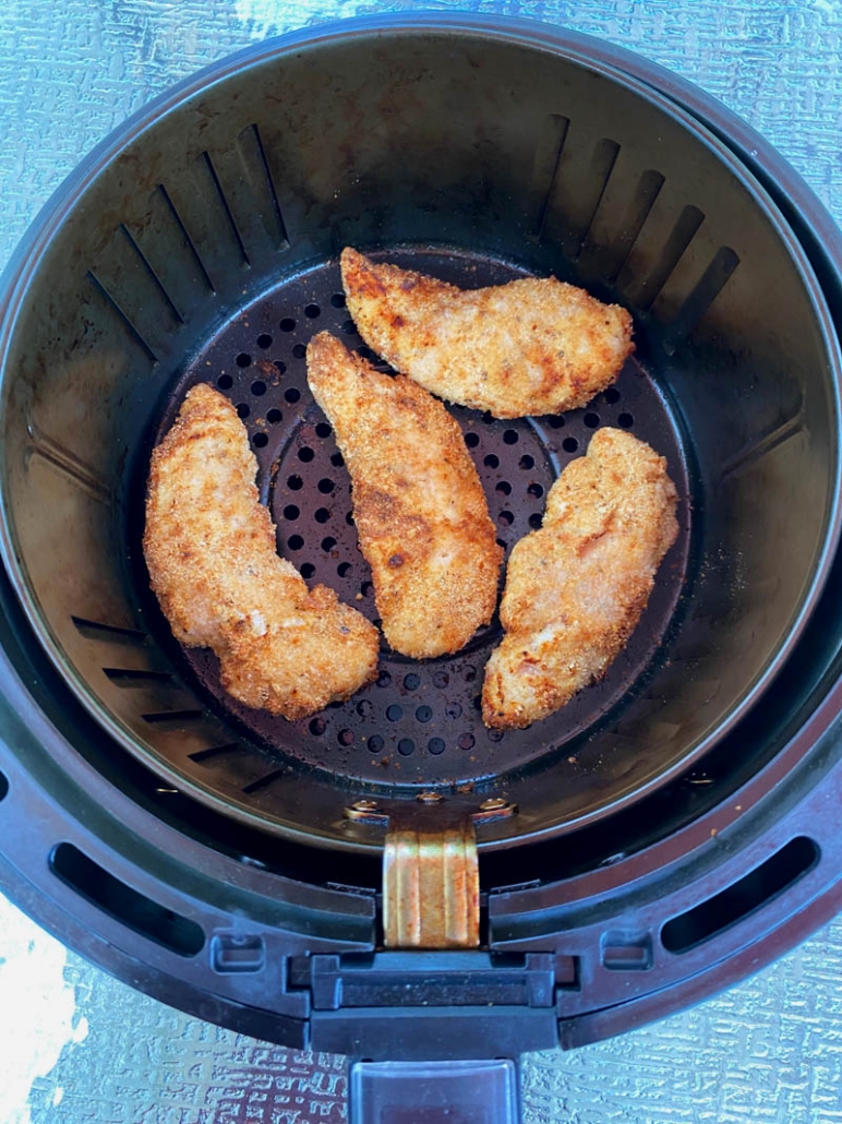 crispy air fried chicken tenders in the air fryer basket 