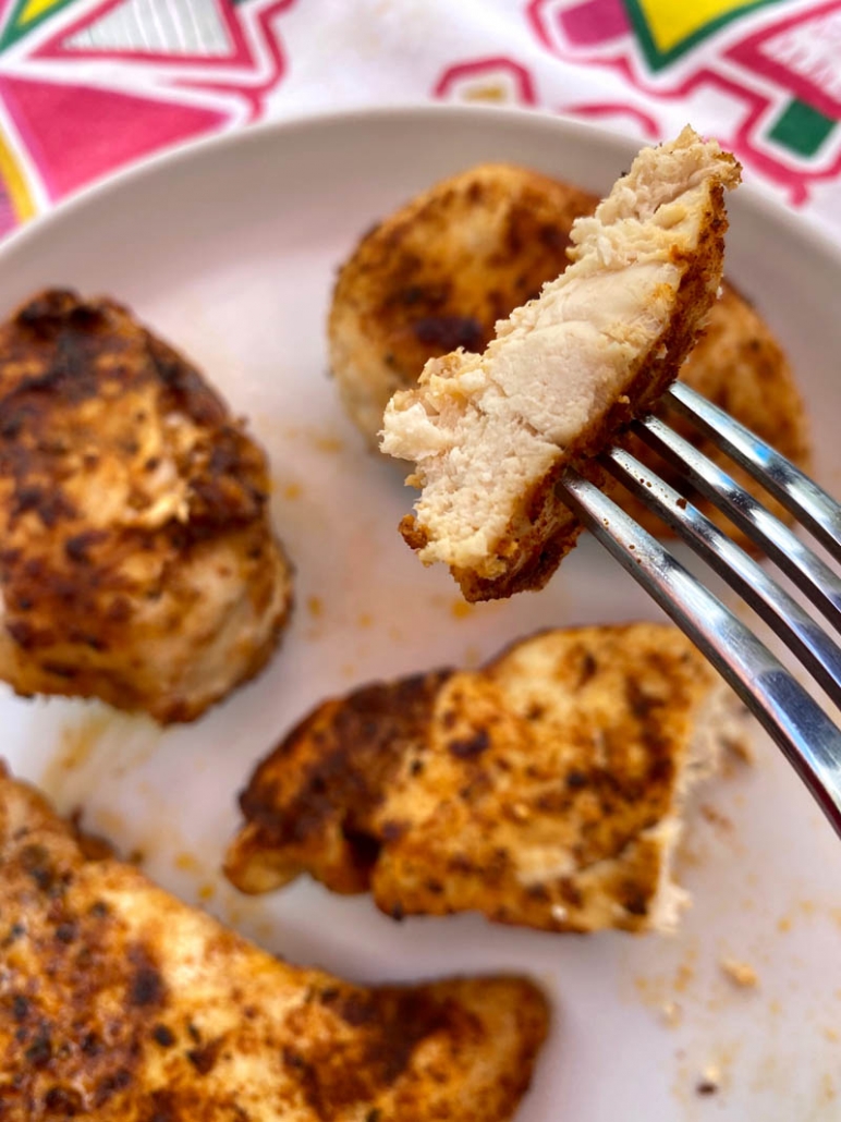 eating a bite of air fryer chicken with a fork. 