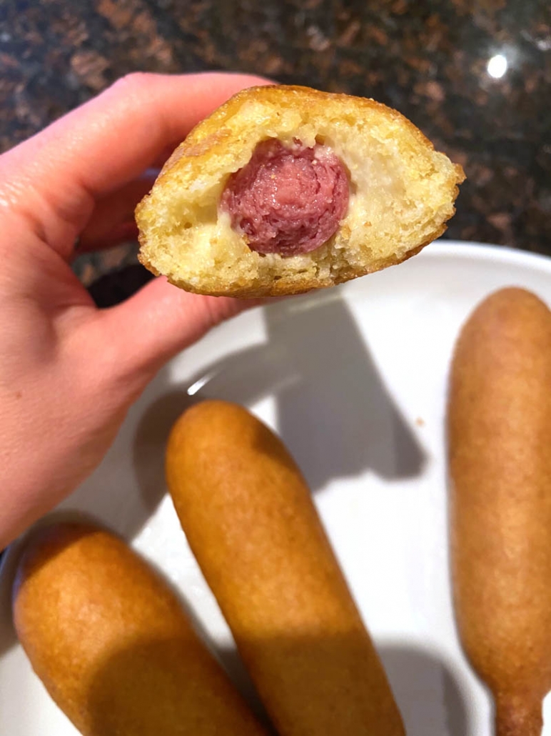 taking a bite out of an air fried corn dog 