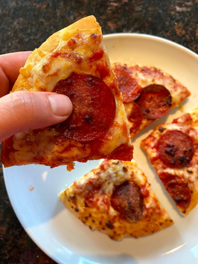 eating a slice of frozen pizza 