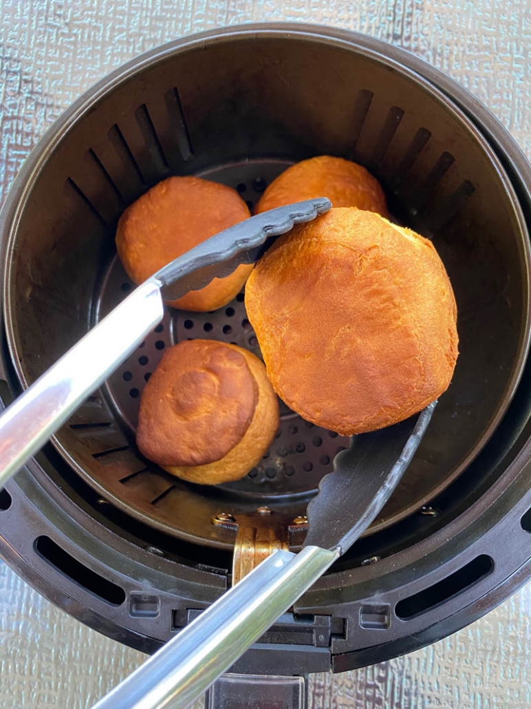 picking up a biscuit with tongs