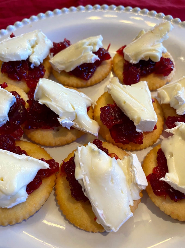 sliced brie and cranberry sauce on a ritz cracker 