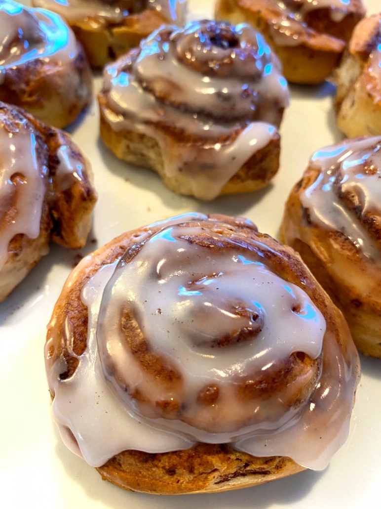 homemade cinnamon rolls topped with icing 