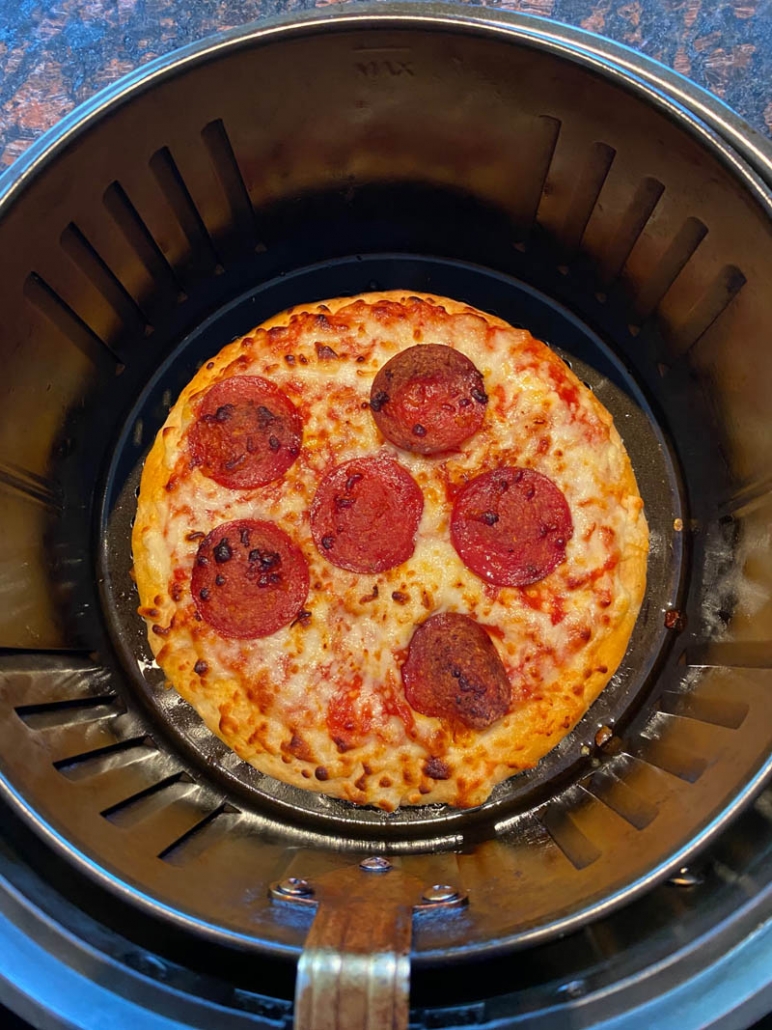 https://www.melaniecooks.com/wp-content/uploads/2020/12/cooking_pizza_air_fryer-772x1030.jpg