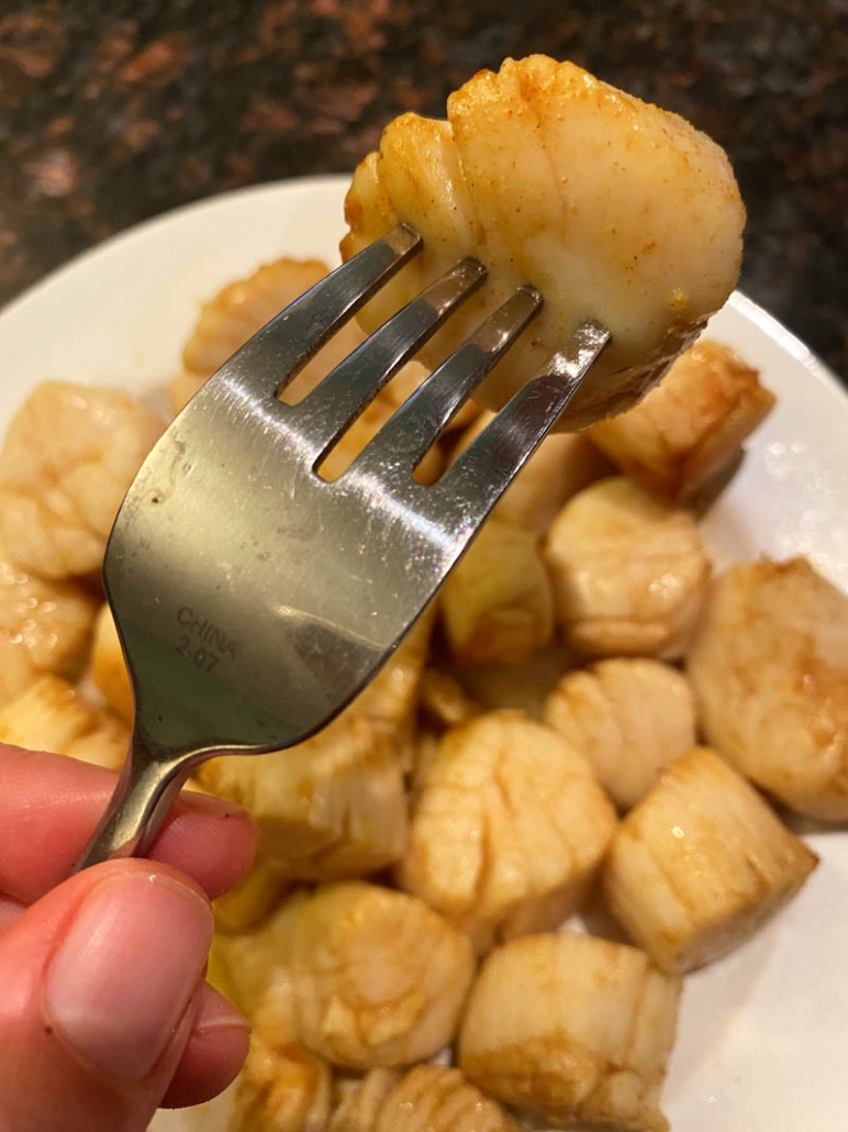 eating a scallop with a fork 