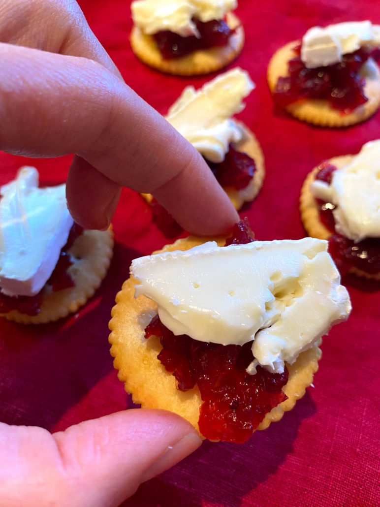 ritz cracker topped with cranberry sauce and brie cheese