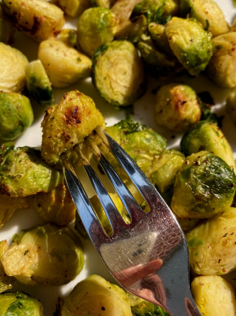 eating garlic brussel sprouts with a fork