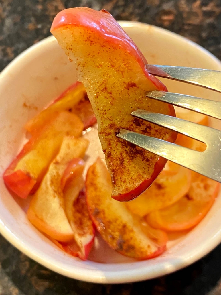 eating cinnamon apples with a fork 