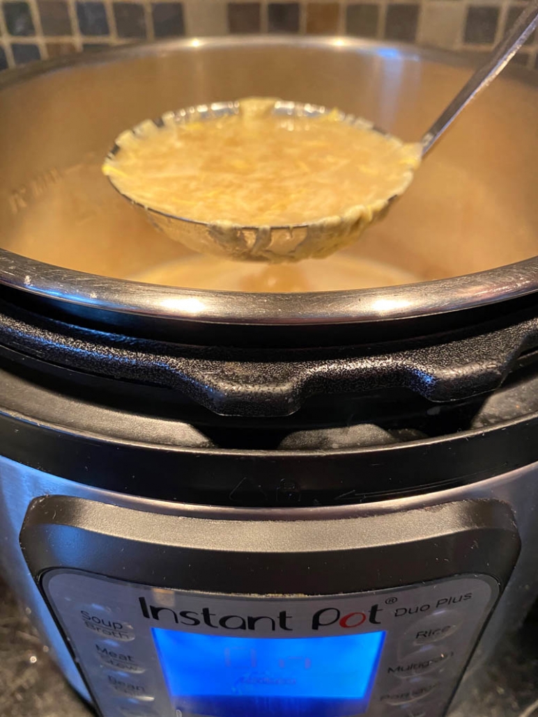 serving egg drop soup with a ladle 