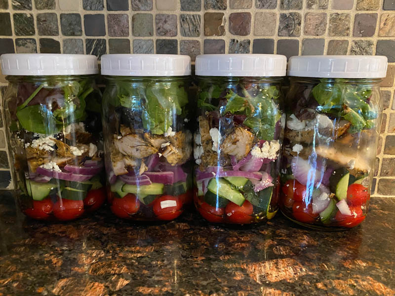 greek chicken salad recipe stored in mason jars