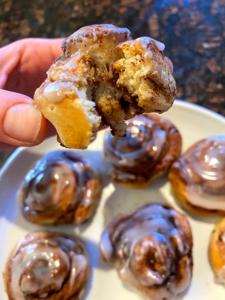 taking a bite out of a cinnamon roll