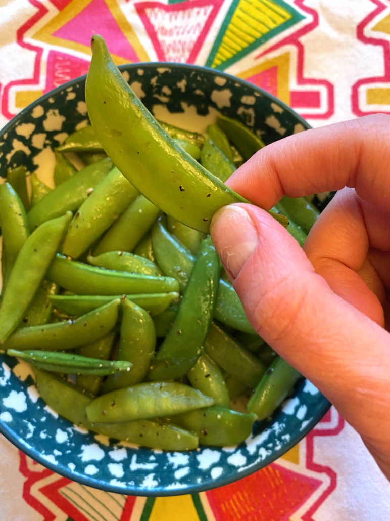 eating a steamed sugar snap pea 