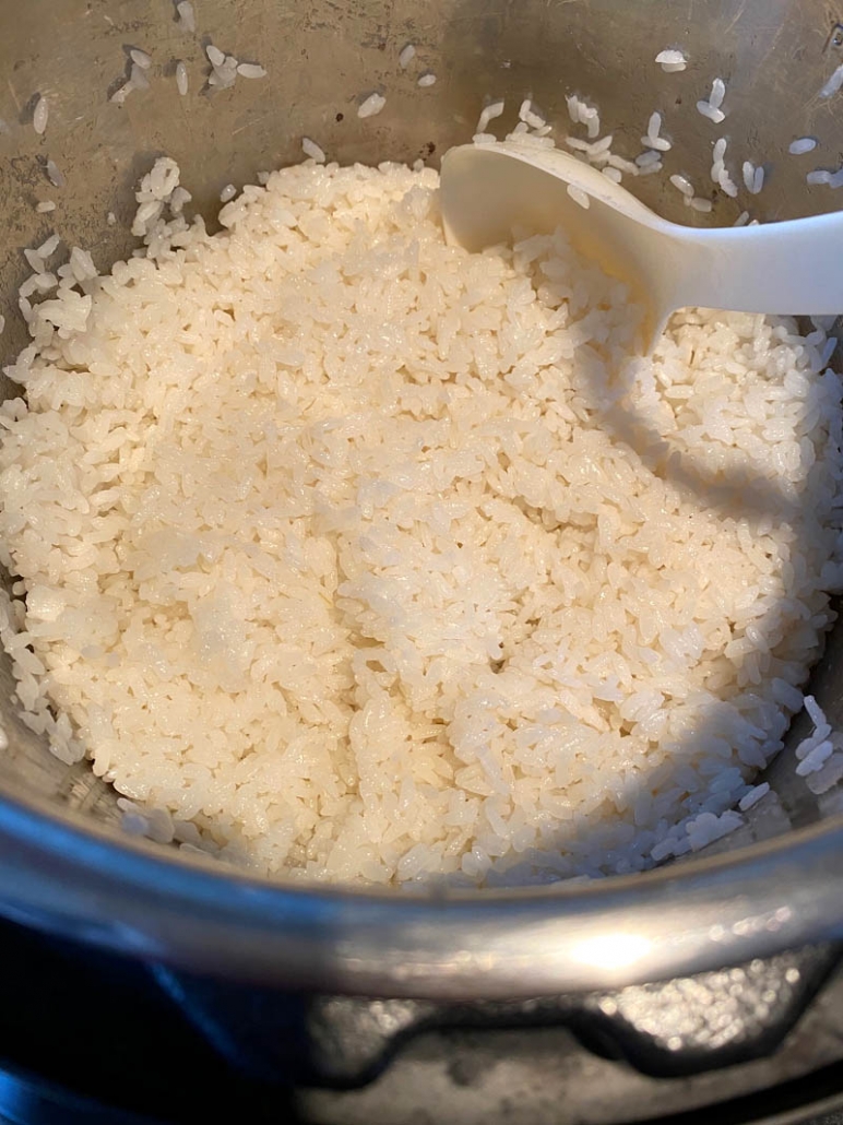 scooping out sushi rice from pot