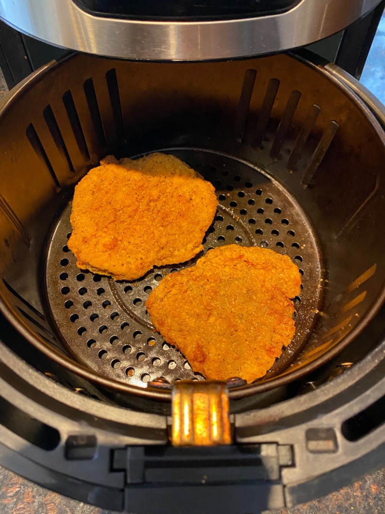 2 chicken fried steaks in the air fryer basket 