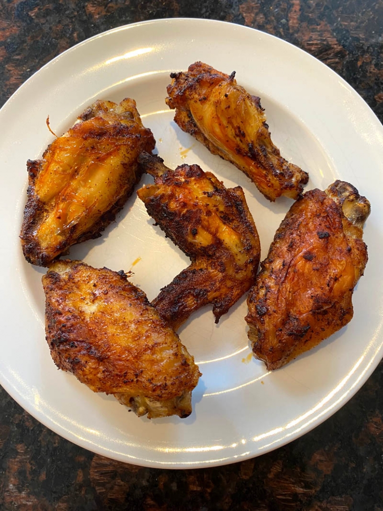 Roasted chicken wings on a white plate