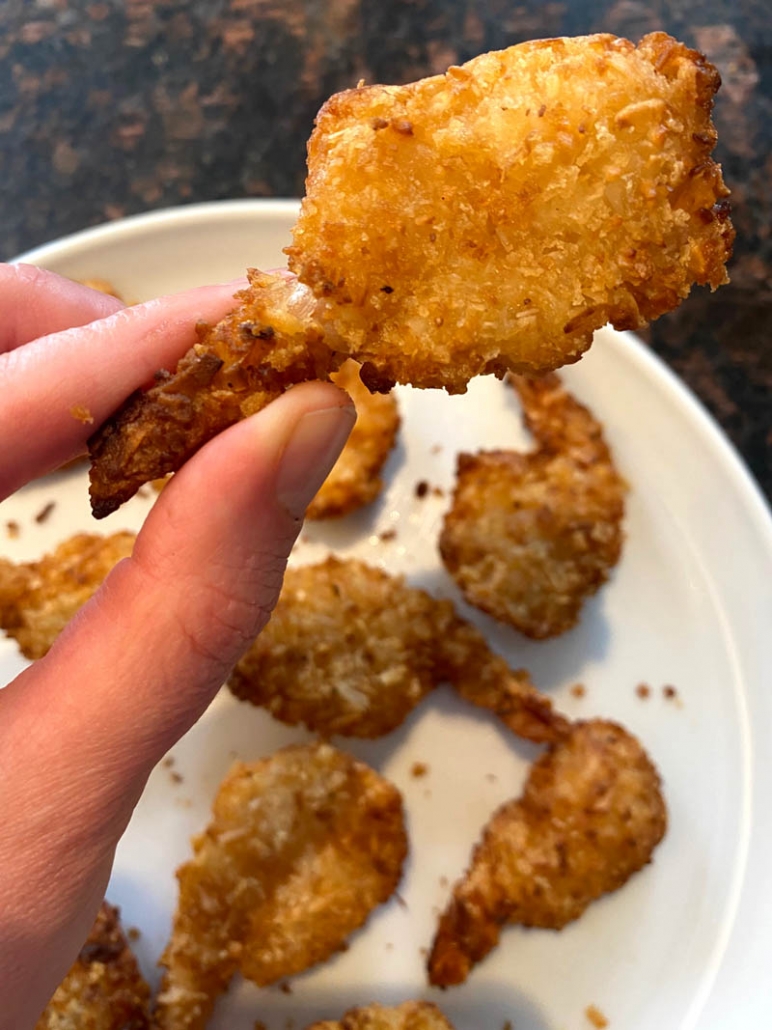 eating fried coconut shrimp 