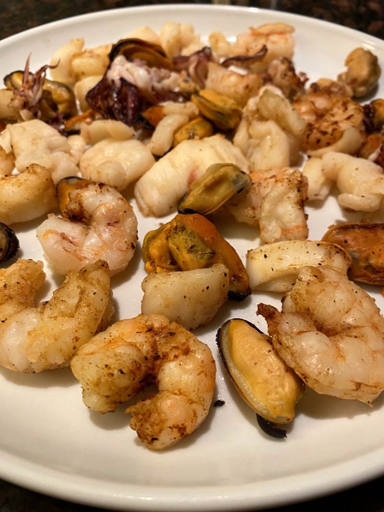 cooked seafood mix on a white plate 