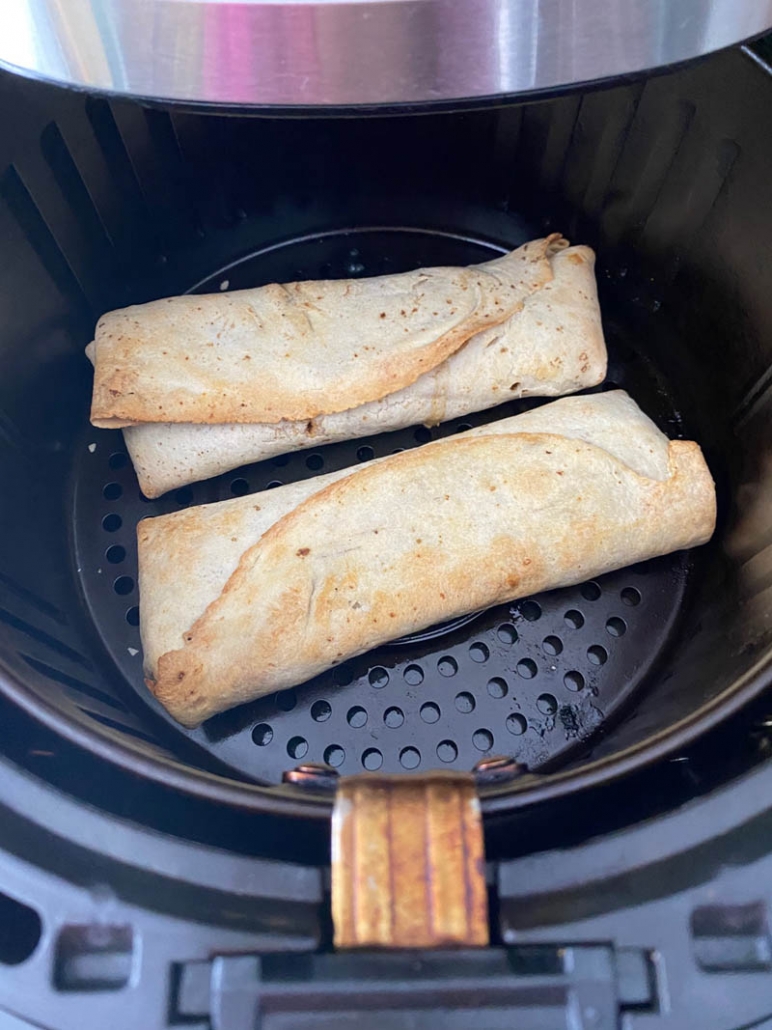 2 chicken burritos on air fryer basket