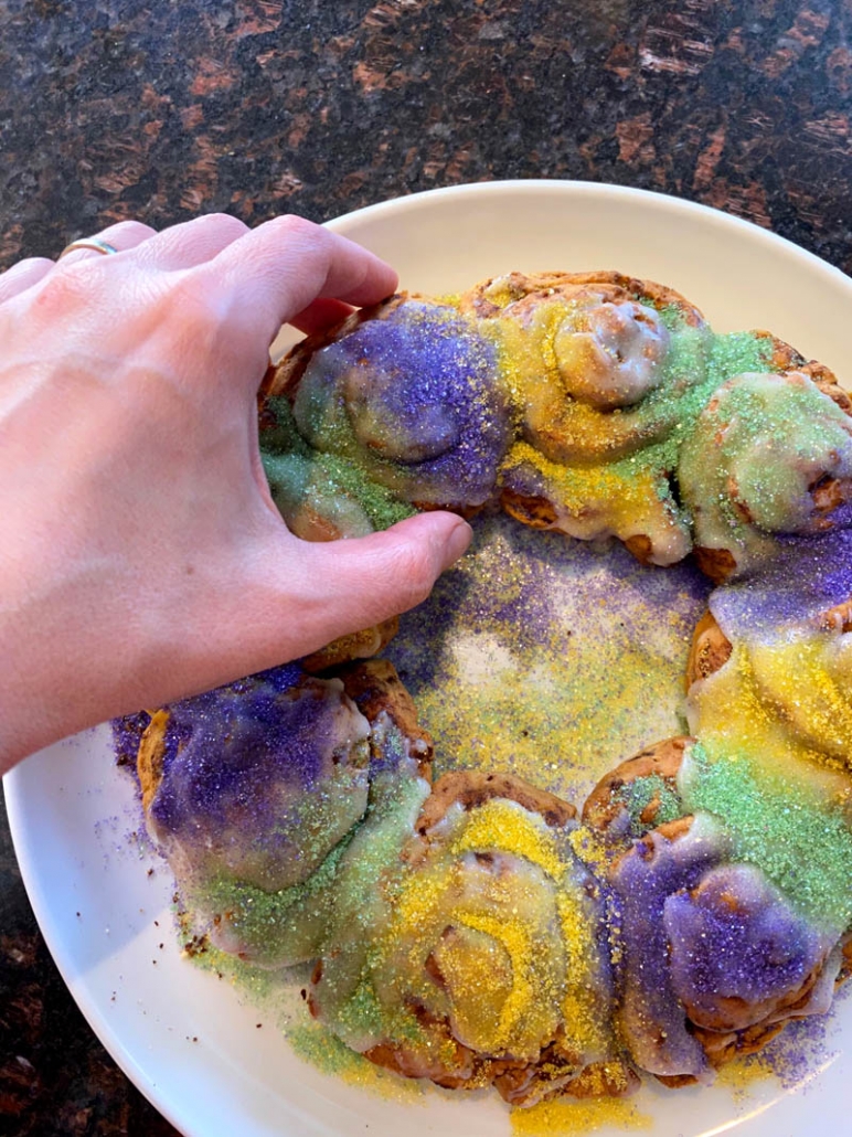hand grabbing a piece of the king cake recipe