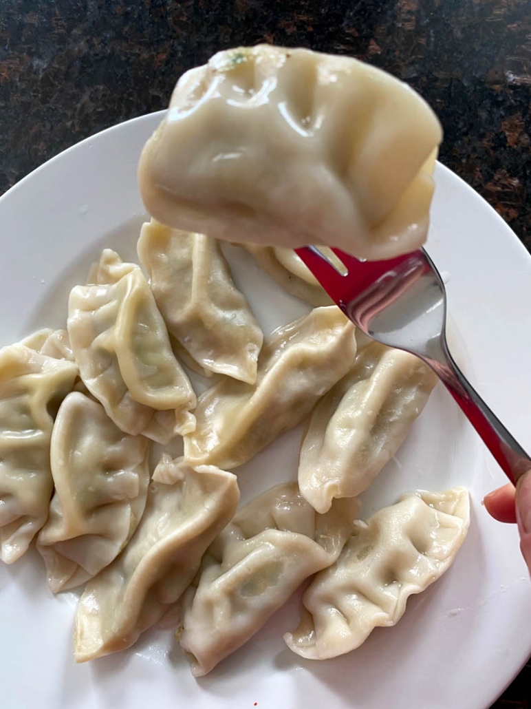 eating a potsticker with a fork 